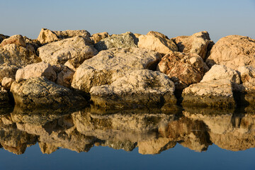 Wall Mural - Reflection of rocks on the sea