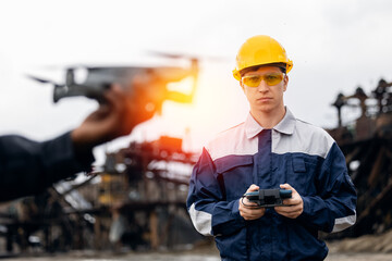 Wall Mural - Utilizing uav drones in sand and ore mining, caucasian male engineer surveying control work in open pit mine