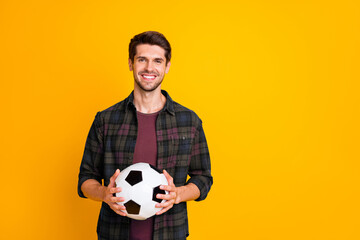 Poster - Photo of cool guy with white and black football ball excited to begin match wear casual plaid shirt isolated yellow color background
