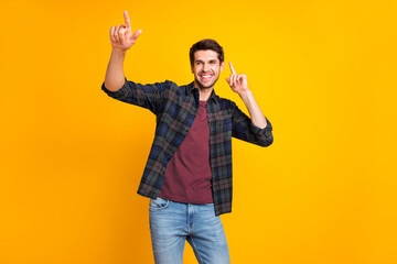 Poster - Photo of nice guy crazy dancer indicating fingers to copyspace inviting friends to dance floor wear casual plaid shirt isolated yellow color background