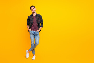 Poster - Full length body size photo of cheerful charming cute handsome man posing in front of camera with hands in pockets isolated over vivid color background
