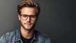 © leymart - Attractive young man with eyeglasses and denim jacket.