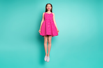 Wall Mural - full length photo of pretty girl jumping with her lisp pouted plump wearing polka dot skirt dress is