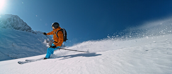 Freeze Motion of Skier Running Down. Powder Snow Exploding. Beautiful Dolomites Landscape. Winter Sports and Activities. Panoramic Format.