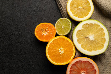 Wall Mural - A close up of several oranges and limes on a table. The oranges are orange and the limes are green