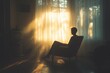 © Mariya - silhouette of a sad thoughtful man sitting in chair by window feeling lonely and anxious in natural light