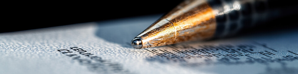 Canvas Print - Close-up of Pen Tip Above Printed Document