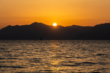 Wall Mural - View of the sunset over the sea and island