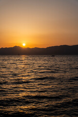 Wall Mural - View of the sunset over the sea and island