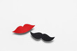 © Pixel-Shot - Male mustache and female lips made of paper isolated on white background