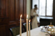 © Дмитрий Чапурин - 3 candles in close-up, with the bride and groom hugging in the background. The background image.
