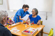 © Koldo_Studio - Caring nurse assisting elderly woman with activities