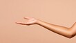 © zakiroff - Outstretched hand against a soft beige background, showcasing smooth skin and elegant fingers, perfect for gestures or presentations, body language concept