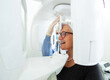 © Antonio Gravante - Dentist preparing elderly woman for dental panoramic radiography