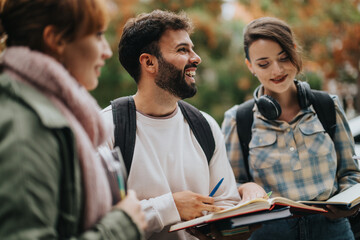 Poster - A group of young students discussing in an outdoor setting, holding books and wearing backpacks. They appear engaged and enthusiastic about their studies. The mood is collaborative and friendly.