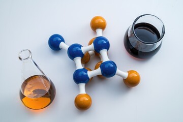 Poster - A molecular model, a flask with amber liquid, and a glass with dark liquid represent chemical experimentation.