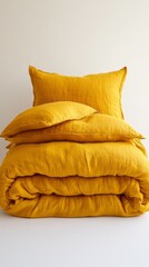 Poster - Soft, textured bedding pieces in a warm yellow hue are artfully arranged for product display. The elegant design is enhanced by soft studio lighting against a crisp white background
