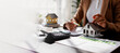 © David - Business mortgage realtor with house model, sitting at desk, real estate agent manager working on calculator and documents, mortgage and property.