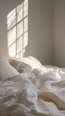 Poster - Gentle shadows fall across wrinkled striped sheets on an unmade bed, complemented by soft morning light. The tranquil atmosphere is perfect for a fresh start to the day
