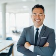 © Robert Kneschke - Confident business director smiling in modern office environment