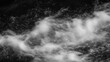 © kept - A close-up view of swirling water waves creating a dynamic pattern in black and white.