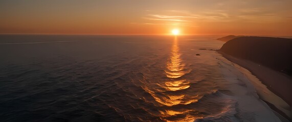 Wall Mural - A stunning view of a coastal sunset with the sun dipping below the horizon while its radiant colors light up the sky and ocean