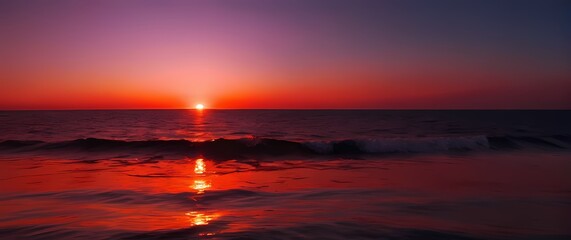 Wall Mural - A stunning red sunset enveloping the tranquil horizon of the sea where reflections of vibrant colors ignite the water with breathtaking splendor