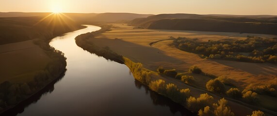 Wall Mural - A serene view of a tranquil river meandering through a golden hour landscape where the warm light caresses both land and water