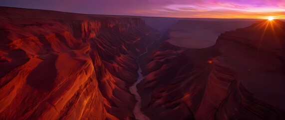 Wall Mural - A dynamic representation of a fiery sunset over an open canyon where the sky morphs into a rich palette of reds oranges and purples