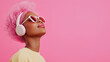 © Helga - person with striking pink hair, wearing sleek headphones, enjoying their favorite playlist against a matching pink background. The image radiates energy and style, ideal for fashio
