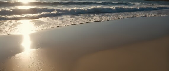 Wall Mural - A captivating view of gentle waves rolling onto a sandy beach where sunlight sparkles off the water creating a mesmerizing reflection