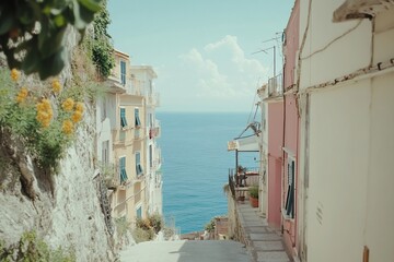 Wall Mural - Coastal alleyway with colorful buildings and ocean view.