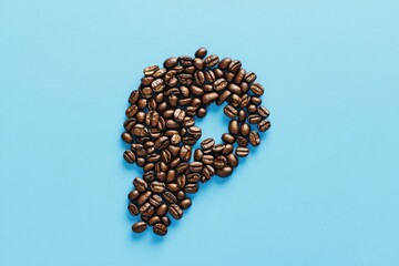 Wall Mural - Coffee beans arranged to resemble a head in profile