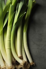 Wall Mural - Fresh green leeks on grey table, top view