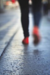 Aufkleber - Blurry photo of a person walking on a wet street capturing the essence of urban movement and life : Generative AI