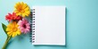 © BokehBox - A vibrant bouquet of colorful daisies rests beside a blank spiral notebook, offering a refreshing and inspiring springtime scene for your projects.