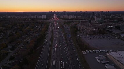 Wall Mural - Busy highway interchange at sunset in ontario, canada, aerial view