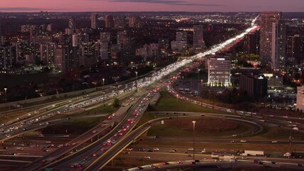 Wall Mural - Highway interchange in Ontario at dusk, with flowing traffic and urban buildings