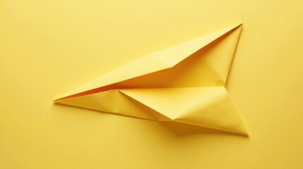 Poster - A Simple Yellow Paper Airplane on a Matching Background, Ready for Flight, Representing Minimalist Design and Childhood Memories