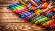 © udomsak - A colorful array of crayons are scattered across a wooden floor, creating a vibrant and playful atmosphere , ground
