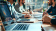 © Prasong Takham - Blurry Group of diverse professionals collaborating and working together on laptops in a modern well equipped office setting  The image conveys concepts of teamwork productivity strategy