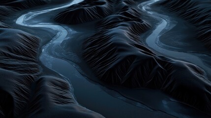 Aerial view of meandering river in dark mountains