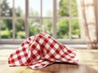 © artwiyanastudio - Red checkered tablecloth on wooden table, window view