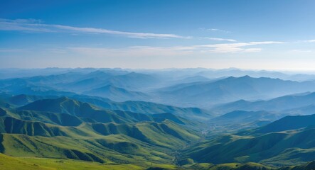 Wall Mural - Majestic mountain range under a clear blue sky showcasing tranquil green hills, creating a serene and peaceful outdoor landscape.