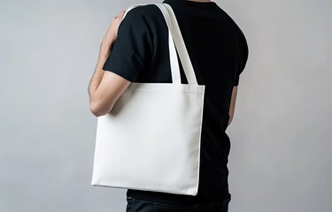 Wall Mural - Man carrying blank tote bag, studio shot, mockup, advertising