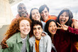 © Xavier Lorenzo - Multiracial young group of diverse teenage friends smiling at camera standing together outside