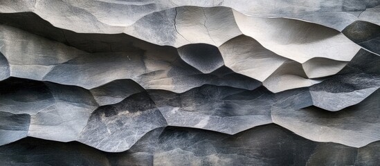 Poster - Textured layered stone wall in varying shades of grey showcasing irregular shapes and rough to smooth surface contrasts for architectural design.