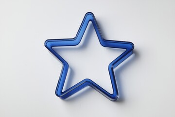 Poster - A vibrant blue star-shaped frame, possibly a cookie cutter or decorative element.