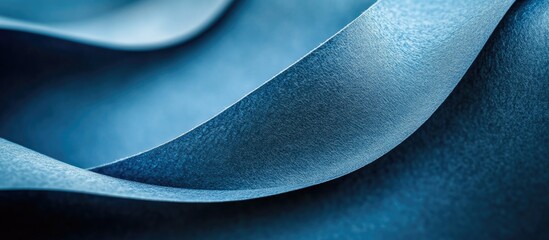 Fototapete - Textured blue paper surface with smooth curves and gradients for creative backgrounds and design elements.