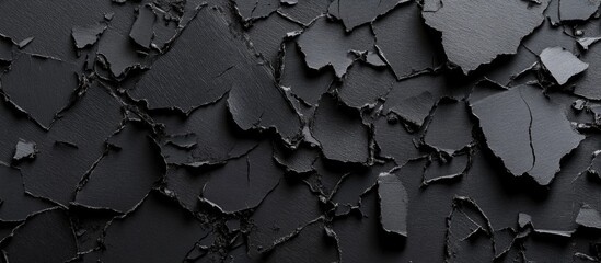 Poster - Textured black grunge background with torn and peeling paper pieces suitable for design projects and creative text overlays.
